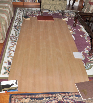 Acclimatizing the teak veneer prior to gluing it to the plywood floor.