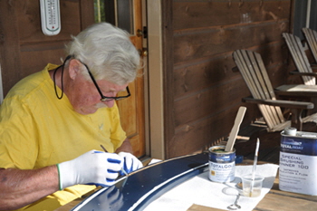 Painting the gold paint on the nameboard.