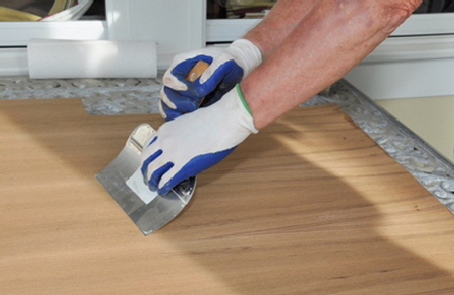 Smoothing veneer after gluing it to the plywood.