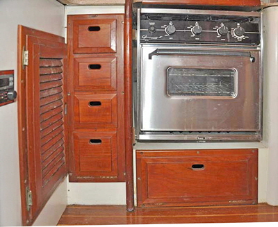 A new stainless steel stove was installed and the cupboards brough forward to be in line with the rest of the panelling.