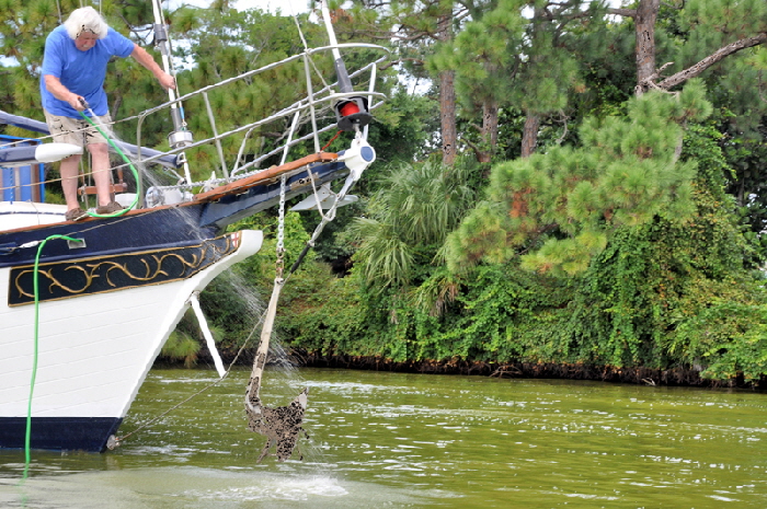 An anchor wash removes all the slime off an anchor and chain before it  has to be done with a  bucket and broom on deck.
